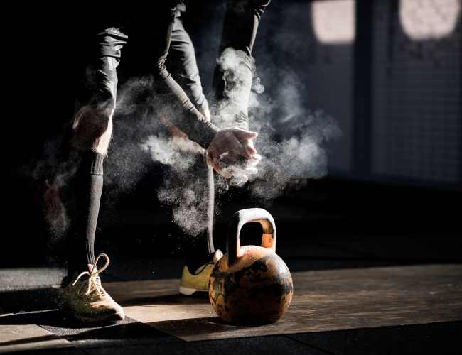 Gym fitness workout: Man ready to exercise with kettle bell